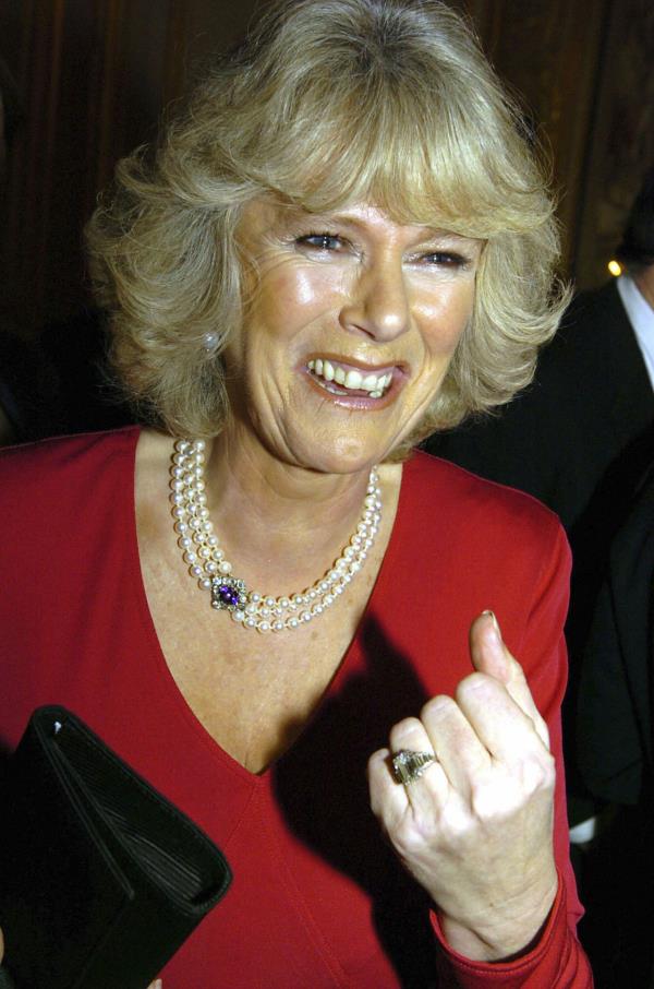 Camilla shows off her engagement ring as she and Prince Charles arrive for a party at Windsor Castle in February 2005.