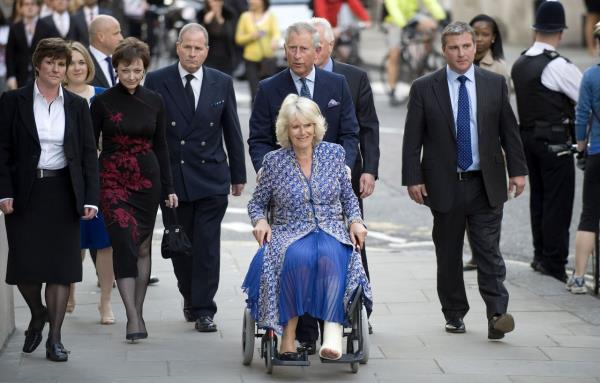 Charles pushes Camilla in a wheelchair as they attend the premiere of "Aida" at the Royal Opera House in Lo<em></em>ndon in April 2010. She had suffered a broken leg weeks prior.