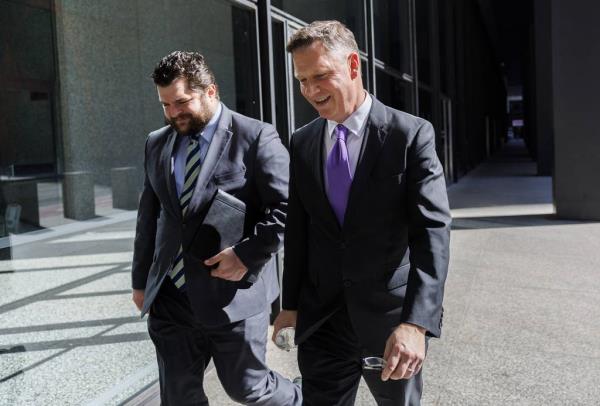 Illinois Appellate Court Justice David Ellis, right, walks outside the Dirksen U.S. Courthouse on April 12, 2023.