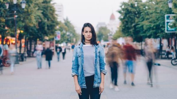 Young Woman Alone in a Crowd