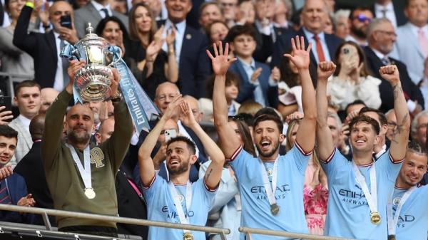 Manchester City manager Pep Guardiola lifts the FA Cup