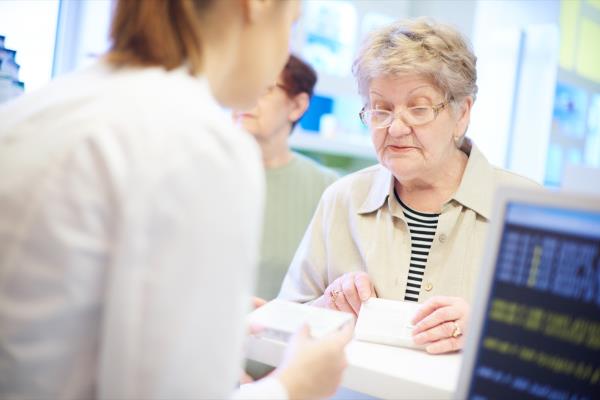 older lady checking out at the register